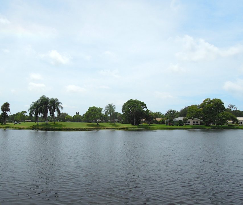 A green on the Meadows’ golf course is seen across one of the development’s 80 lakes and ponds. Photo by Robert Hackney